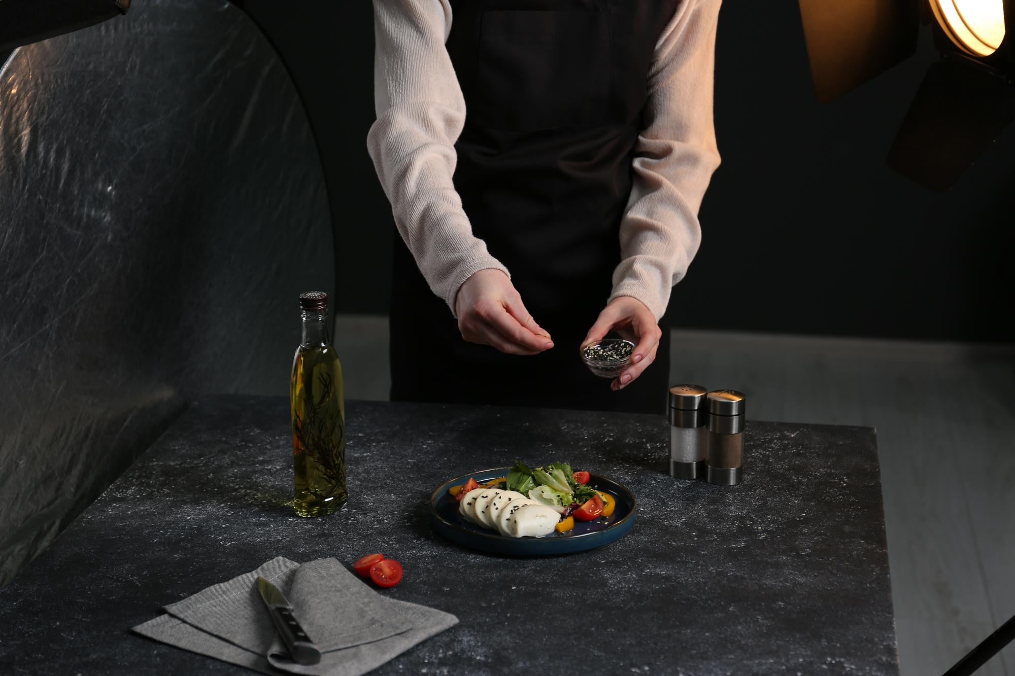 Chef arranging dessert on stone slab